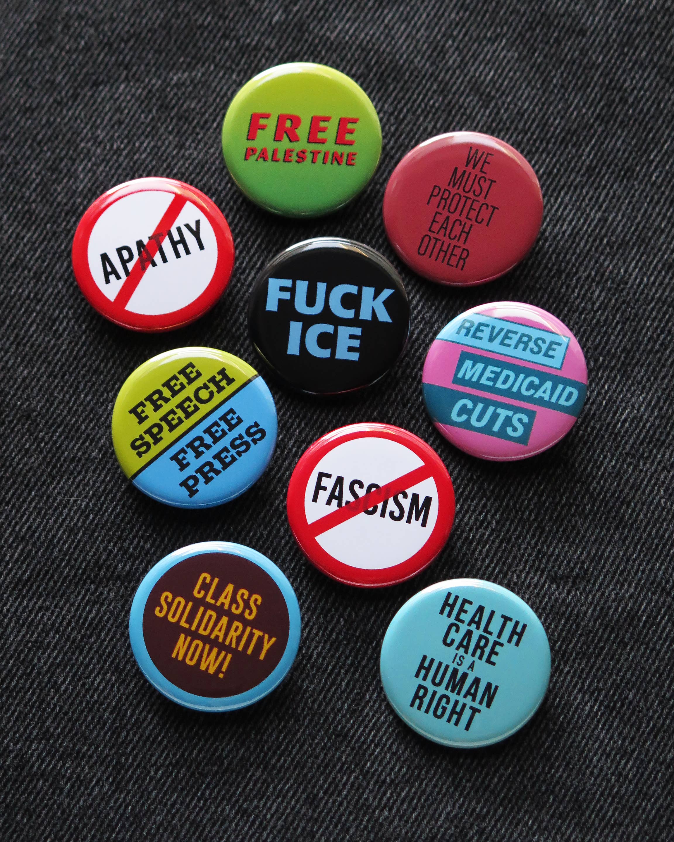 We Must Protect Each Other Pinback Button